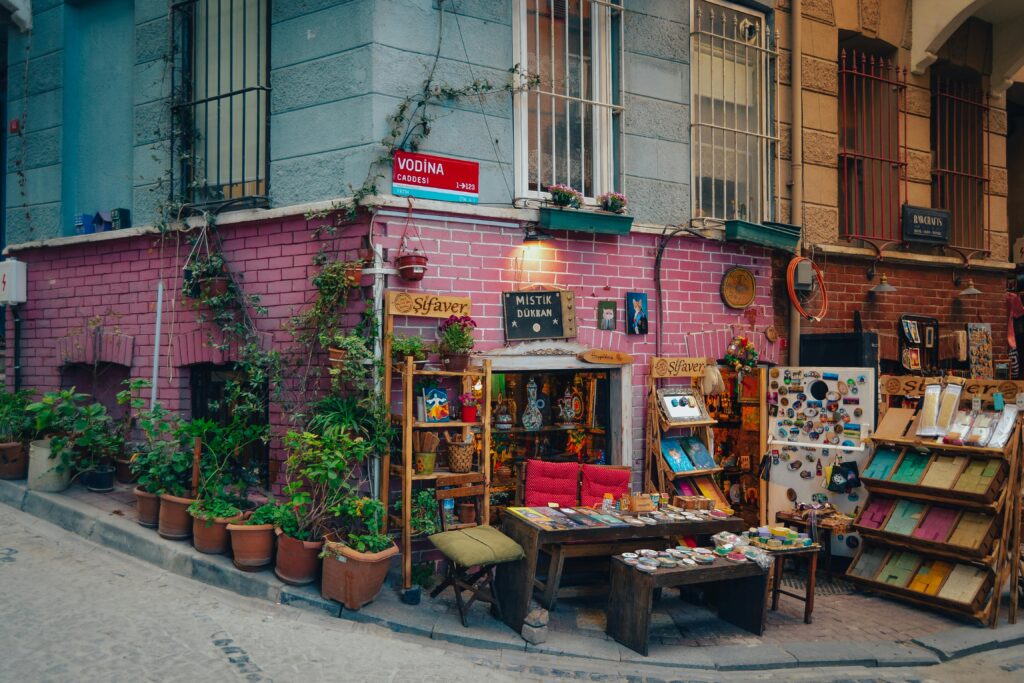 Vibrant street corner in Istanbul showcasing a quaint store with colorful merchandise and potted plants.